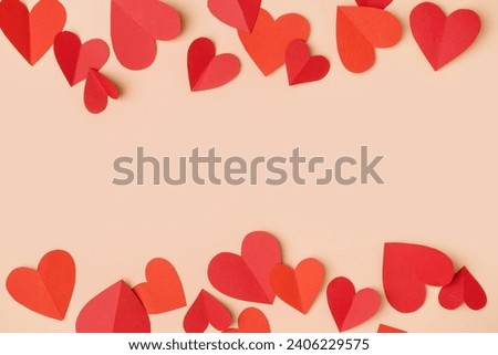 Red paper hearts on yellow background. Valentine's Day celebration