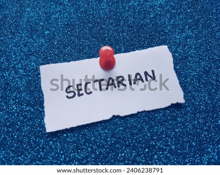 Sectarian writing on beach sand background. Royalty-Free Stock Photo #2406238791