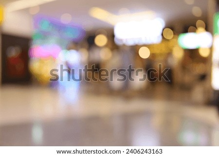Defocused shopping mall background. Abstract blur and bokeh beautiful luxury shopping mall indoor with crowd of people