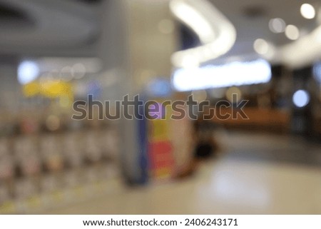 Defocused shopping mall background. Abstract blur and bokeh beautiful luxury shopping mall indoor with crowd of people