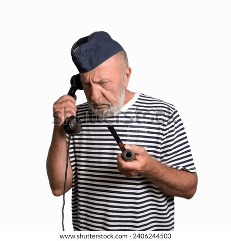 An old sailor with a smoking pipe. receives a command over the phone. White background. portrait