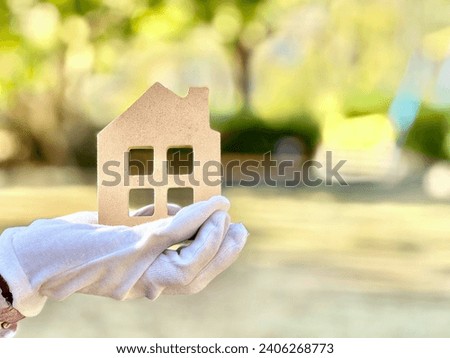 Hand in white gloves holding household items Royalty-Free Stock Photo #2406268773