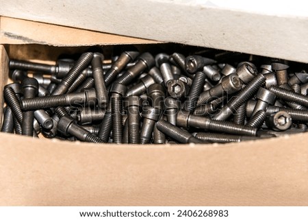Cardboard box with small construction storage compartments filled with screws, nuts, bolts workshop tools