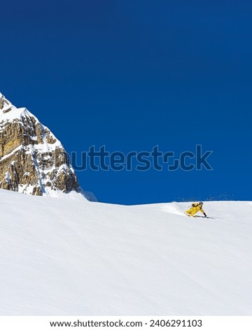Ski instructor skiing in Courchevel off piste, Valley Des Avals, French Alps, France Royalty-Free Stock Photo #2406291103