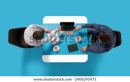 Creative collage. Aerial view of two confident man, entrepreneurs sitting at common table with document and laptop and discussing work tasks. Concept of business lunch, morning meeting, briefing. Ad Royalty-Free Stock Photo #2406295471