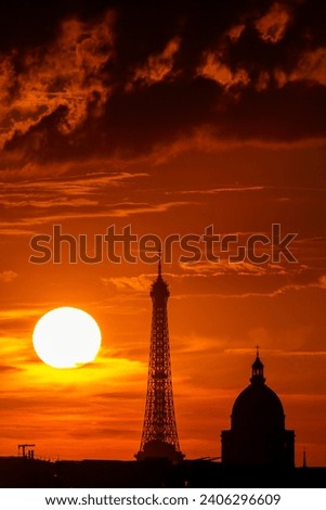 Sunset in Paris: Eiffel Tower silhouetted against a crimson sky, symbolizing the city's timeless romance.