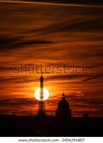 Sunset behind the Eiffel Tower: a perfect alignment casting a radiant glow, marking Paris's day-to-night transition.