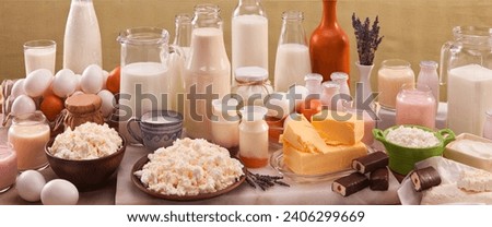 Lovely still lifes of raw dairy products. This is fresh milk, sour cream. Different cheeses. Butter and cottage cheese. 