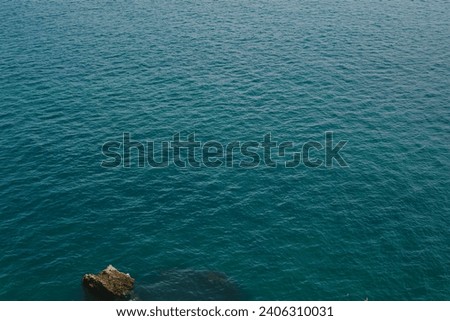 View of the blue water of the ocean. Beautiful water pattern. The azure surface of the sea