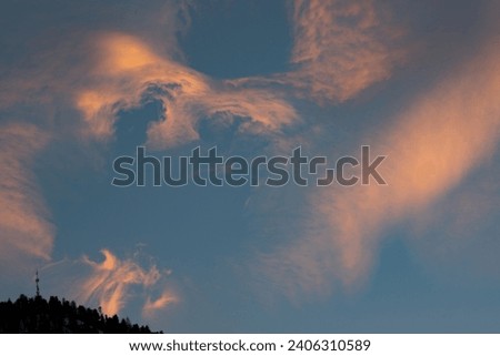 Zermatt, Switzerland - December 24, 2023: Cloud formations during sunset over The Matterhorn Glacier Paradise range.