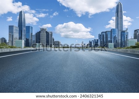 Empty asphalt road and city buildings skyline in Shenzhen Royalty-Free Stock Photo #2406321345