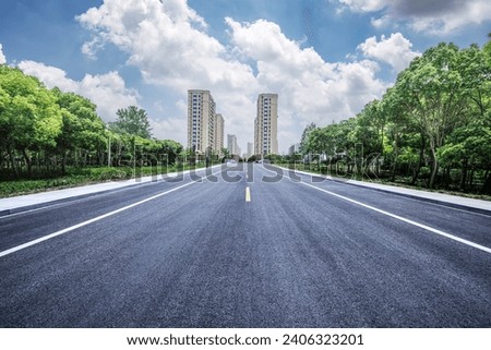 Straight road and woods and architectural landscape Royalty-Free Stock Photo #2406323201
