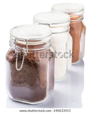 Instant coffee, chocolate drink powder and sugar in glass jar container