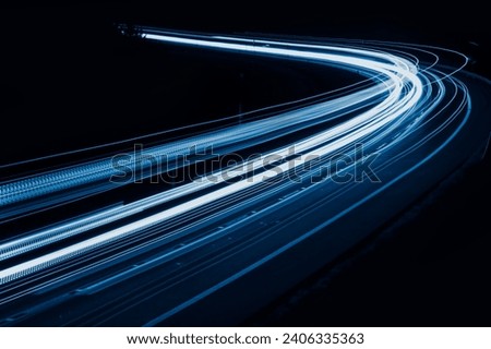 blue car lights at night. long exposure. Royalty-Free Stock Photo #2406335363