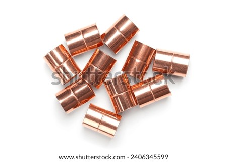 Copper sleeves, weld-in sockets, soldering fittings, and connectors for installation on copper pipes, and for use in plumbing or mechanical applications. With a diameter of 15 mm and of 20 mm length. Royalty-Free Stock Photo #2406345599