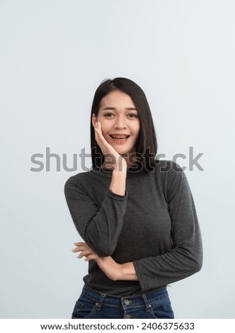 Asian woman braces. Teeth braces on the white teeth of women to equalize the teeth. Bracket system in smiling mouth, close up photo teeth, macro shot, dentist health concept. Royalty-Free Stock Photo #2406375633