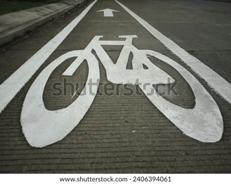 a picture of a bicycle with white paint on the side of the road as a sign for bicycle users

￼

￼

