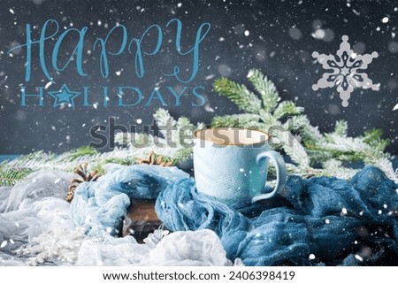 Wishing happy holidays greeting card, mug of coffee on dark and blue winter background Royalty-Free Stock Photo #2406398419