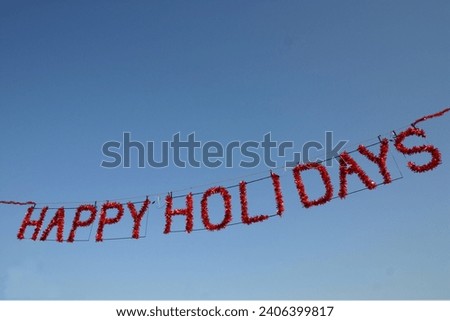 Happy holidays banner hanging in the sky Royalty-Free Stock Photo #2406399817