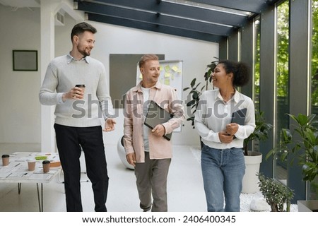 Colleague team going to office workstation after coffee break Royalty-Free Stock Photo #2406400345