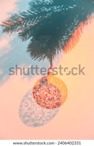 Christmas ball on Christmas tree, creative photo, new year, christmas. Color of the Year 2024 Peach Fuzz. Selective focus