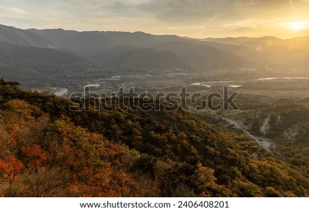 Sunset in the mountains, sunny sky, autumn, town