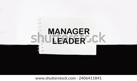 Manager and leader, written on a notepad. Beautiful white and black background, copy space.