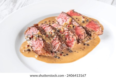 Steak au poivre - french steak with peppercorn sauce Royalty-Free Stock Photo #2406413167