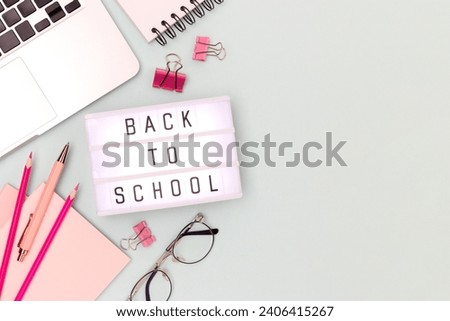Back to school. Layout with lightbox, eyeglasses, laptop and stationery on a blue background. Workspace for e-learning.