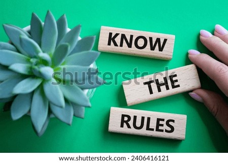 Know the rules symbol. Wooden blocks with words Know the rules. Businessman hand. Beautiful green background with succulent plant. Business and Know the rules concept. Copy space.
