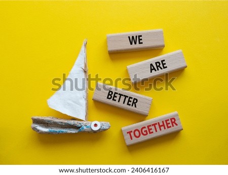 We are better together symbol. Wooden blocks with words We are better together. Beautiful yellow background with boat. We are better together concept. Copy space.