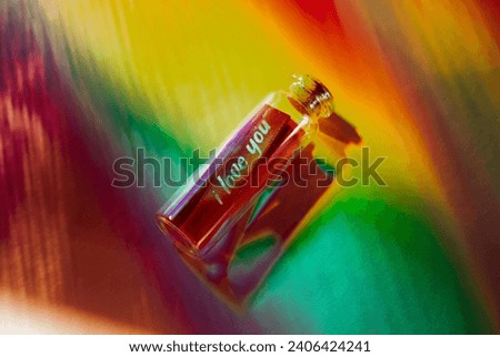 Love message in a glass bottle. Text 'I love you' in a jar on multicolored rainbow background. Confession for Valentine's Day. LGBT concept.