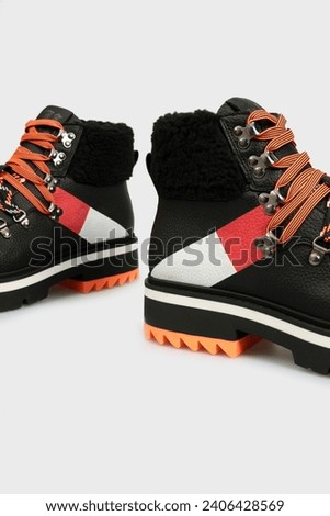 Black women's fashion combat boots isolated on white background. Female classic autumn Timberland shoes. Leather laced, lace up casual footwear with metal rivets, rough sole, fur outside. Template