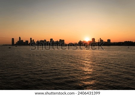 
A city skyline with a body of water and a boat in the distance