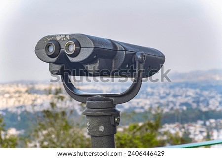 binoculars installed on the viewpoint in the Panoramic view from the Observatory on the hill of the Macuiltépetl Ecological Park surrounded by nature Royalty-Free Stock Photo #2406446429