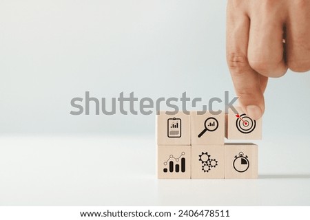 Business development concept. Hand arranging wood block stacking with business strategy, Action plan, Goal targeting the business success. Setting sale mission objective achievement. Leadership team.