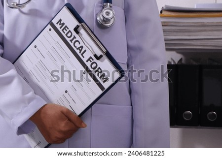 Close up of the ears of a professional female doctor in uniform taking notes in a notebook Medical therapist filling out medical documents. Clipboard. Patient form. Illness history, prescription