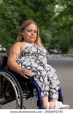 International Wheelchair Day , March 1st Smiling. Pretty Young Woman With Short Stature Sitting In Wheel Chair In Outdoor. Park On Background. Person With Special Needs Enjoys Social Life. Vertical Royalty-Free Stock Photo #2406491545