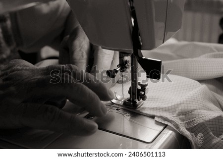 The process of sewing a blouse using an electric sewing machine - monochrome photo
