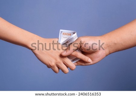 Businessmen hand shaking with money in hands isolated on blue background. Bribery, corruption and venality concepts Royalty-Free Stock Photo #2406516353