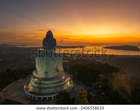 Aerial view scenery yellow light at horizon at sunrise in front of Phuket Big Buddha
the golden sun shines through the clouds.
The beauty of the statue fits perfectly with the charming nature. 
