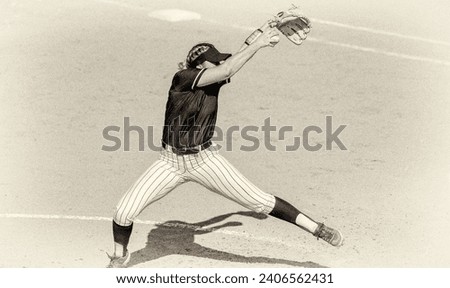 A Female Softball Player Is In Full Windup Pitching Antique Grainy Monochrome