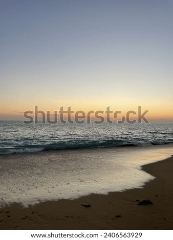 A beautiful picture of calm beach at the time of sunset with sun flashing the beautiful colours on sky and water.