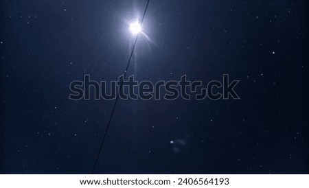 This is a photo of the moon and stars (Milky Way). In the dark night sky, the brilliance of the Milky Way fills the cosmos with infinite beauty.