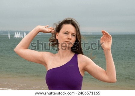 Young woman practicing yoga on the beach at the Baltic Sea in Poland