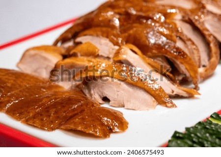 Peking Duck, Chinese roast crispy duck served with hoisin sauce, pancakes, cucumber and spring onions.