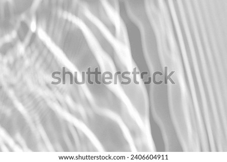 Blurred defocused water texture overlay effect for photo and mockups. Organic drop diagonal shadow and light caustic effect on a white wall. Shadows for natural light effects Royalty-Free Stock Photo #2406604911