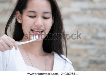 Portrait of a young asian woman with braces on her teeth