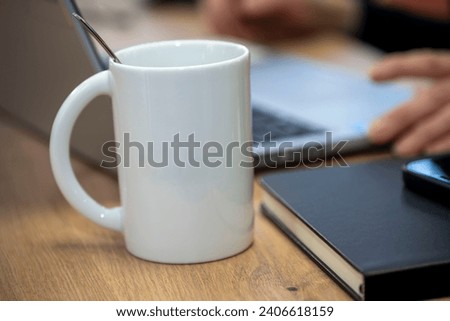 white mug cup on a desk with writing area