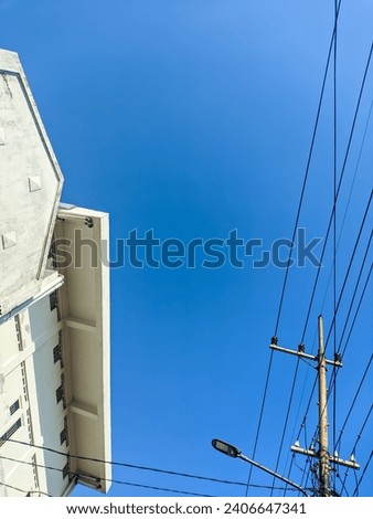 a blue sky with electricity poles and wires
